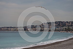 Morning waves on pebble beach in Nice, France