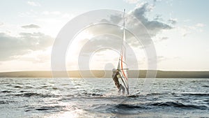 Morning windsurfing on the lake sunrise