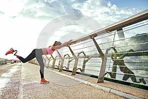 Morning workout. Disabled athletic woman with prosthetic leg in sportswear doing sport exercises while standing on the