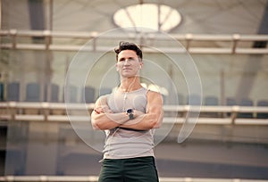 morning workouts with a personal trainer with a stopwatch. Young man checks the time on his sports watch. Handsome