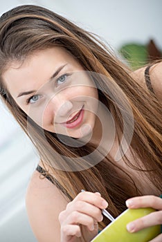 At morning, young and smiling woman eating cereals