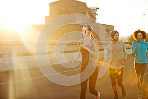 Mornings are the quietest time to run. three friends out jogging in the city in the early morning.