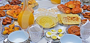 Moroccan breakfast coffee, tea, pancakes, jam, orange juice, egg photo