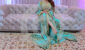 The Moroccan caftan is women`s traditional costume. It is considered one of the oldest traditional clothes in the worl photo