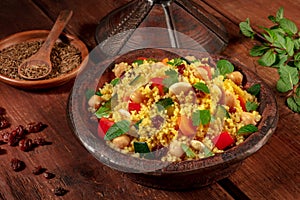 Moroccan couscous in a tagine with ingredients