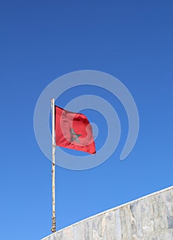 Moroccan Flag flying in the air by the beach in Agadir, Morocco