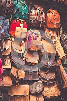 Moroccan leather goods bags in a row at outdoor market