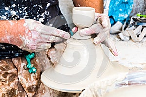 A moroccan pottery maker creates ceramics in a workshop in old medina of Fez, Morocco, Africa