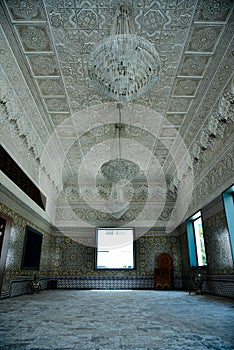 Moroccan room decorated with traditional Moroccan zellij with lots of expensive antiques.