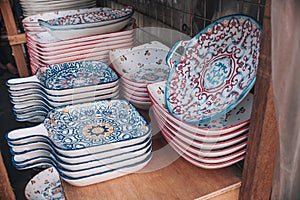 Moroccan style kitchenware for sale at a local flea market store. Plates are separated with thin wax paper