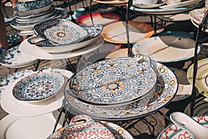 Moroccan style kitchenware for sale at a local flea market store. Plates are separated with thin wax paper