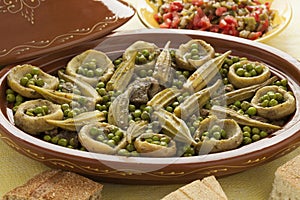Moroccan tajine with meat, okra, green peas and artichoke hearts photo