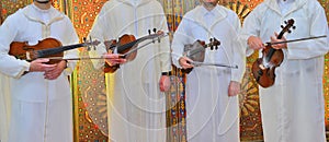 Moroccan violinists wearing djellabas.