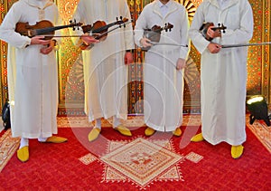 Moroccan violinists wearing djellabas.