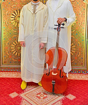Moroccan violinists wearing djellabas.