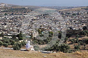 Moroccan woman in golden djellaba and white hijab