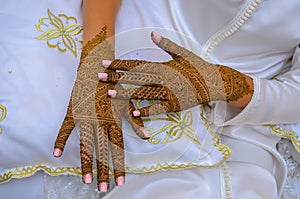 Moroccan woman with traditional henna painted hands.
