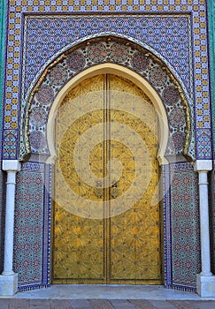 Morocco, Fez, Islamic inscribed brass arched door and glazed tile surround