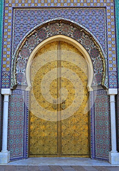 Morocco, Fez, Islamic inscribed brass arched door and glazed tile surround photo