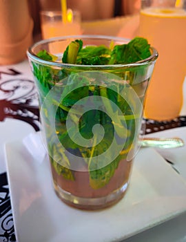 Moroccon mint tea served in a transparent glass photo