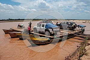 Vehicles embark on barges to cross the river