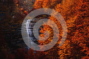 Morricana Waterfalls in Monti della Laga, Abruzzo, Italy, in the full autumn season with red and orange leaves