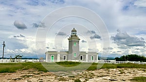 Morrillos Light surrounded by a field under a cloudy sky in Puerto Rico photo