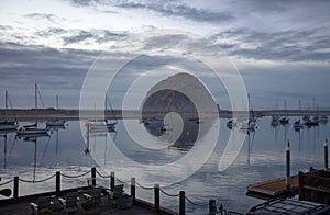 Morro Rock reflecting in Morro Bay harbor at twilight on the Central Coast of California United States