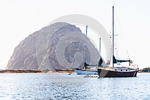 Morro Rock and yachts in the bay at anchor. Morro Bay harbor, California