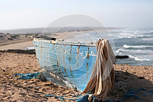 Morroco fisherman old boat on the sandy beach photo