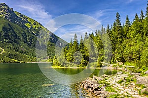 Morskie Oko mountain lake, surrounding forest, Miedziane and Opalony Wierch peaks with Schronisko przy Morskim Oku shelter house photo