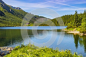 Morskie Oko mountain lake, surrounding forest, Miedziane and Opalony Wierch peaks with Schronisko przy Morskim Oku shelter house photo