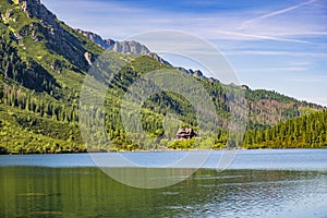 Morskie Oko mountain lake, surrounding forest, Miedziane and Opalony Wierch peaks with Schronisko przy Morskim Oku shelter house photo
