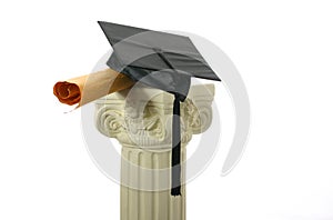 Mortar board and diploma on pedestal II