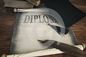 Mortar board and diploma, with text diploma