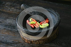 Mortar contains colorful chilies, ready to be pulverized and processed