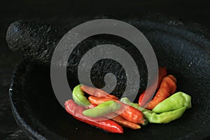 Mortar contains colorful chilies, ready to be pulverized and processed