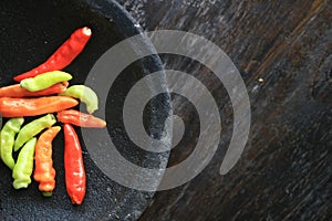 Mortar contains colorful chilies, ready to be pulverized and processed