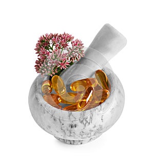 Mortar with flowers and pills on white background