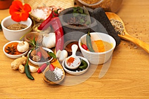 Mortar, food and spices on table for cooking gourmet meal, chili seasoning or flavor pestle. Pepper vegetables, kitchen