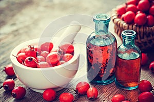 Mortar of hawthorn berries, two tincture bottles and thorn apple