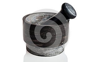 Mortar with a pestle for grinding and crushing spices, peppers and herbs, heavy stone, isolated on a white