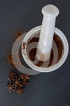 Mortar and Pestle with Ground and Whole Star Anise Vertical