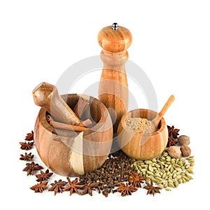 Mortar with pestle, hand mill and spices set isolated on white