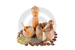 Mortar with pestle, hand mill and spices set isolated on white