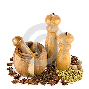 Mortar with pestle, hand mill and spices set isolated on white