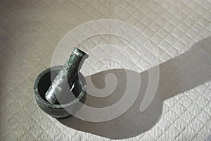 mortar and pestle on textured surface