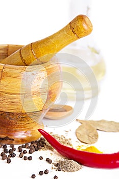 Mortar with pestle, variety of spices and oil