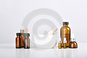 Mortar and scientific laboratory glassware with medicine bottles and clear liquid solution, Drug research