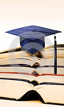 Mortarboard on books